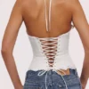 Zizi hvit halterneck-korsetter-topper med broderie anglaise